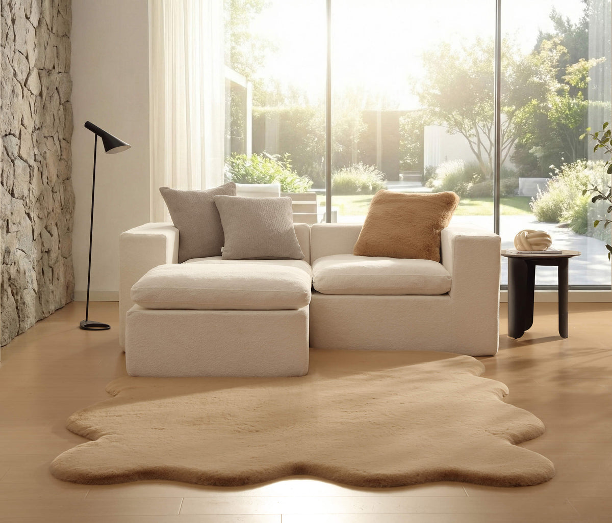 Large tan faux fur area rug with dense shag and rounded edges