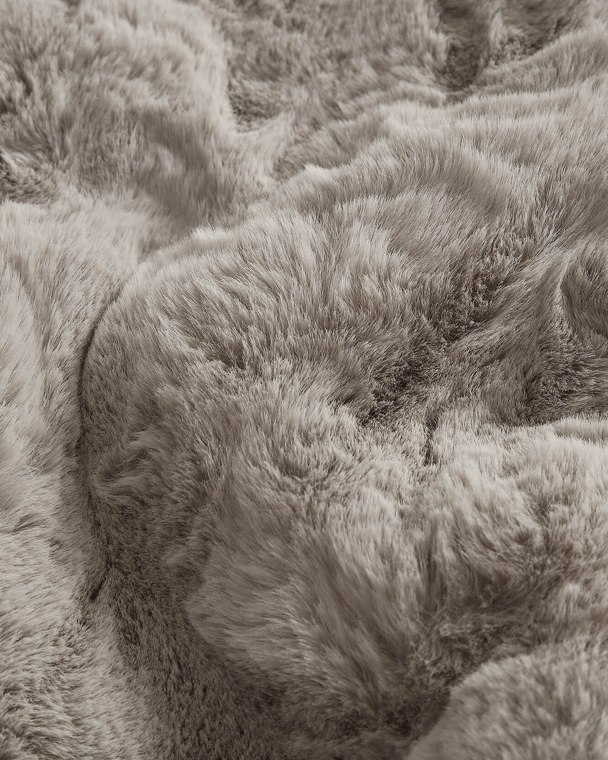 Close-up of grey faux fur rug fibers with dense shag pile