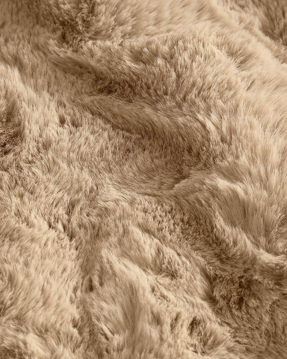 Tan faux fur rug pile close-up with dense shag texture