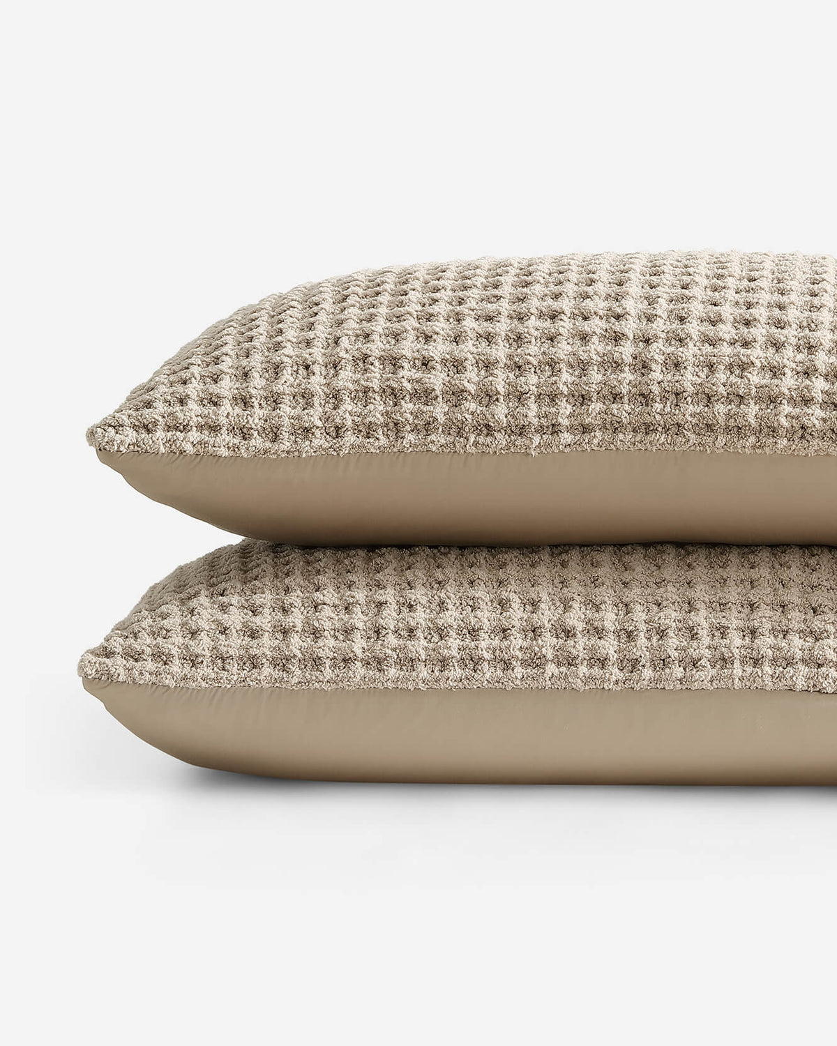Folded waffle-textured comforter layers with beige back