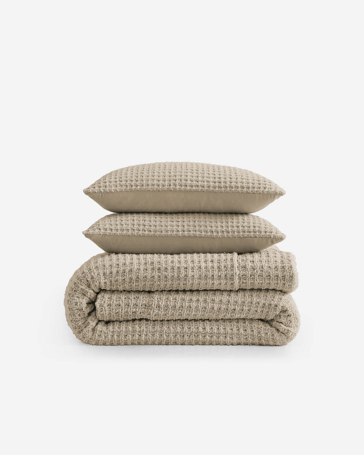 Taupe waffle comforter with matching shams, neatly stacked