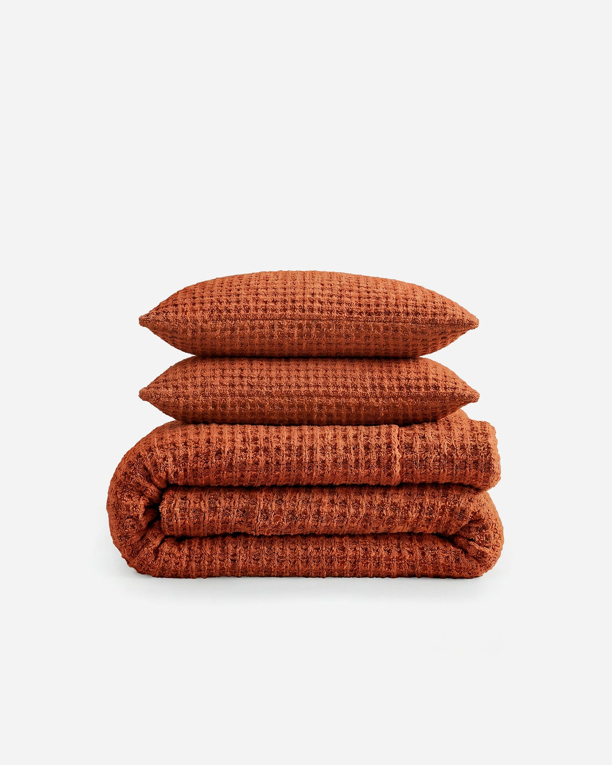 Waffle comforter set in cinnamon orange: folded comforter with two shams