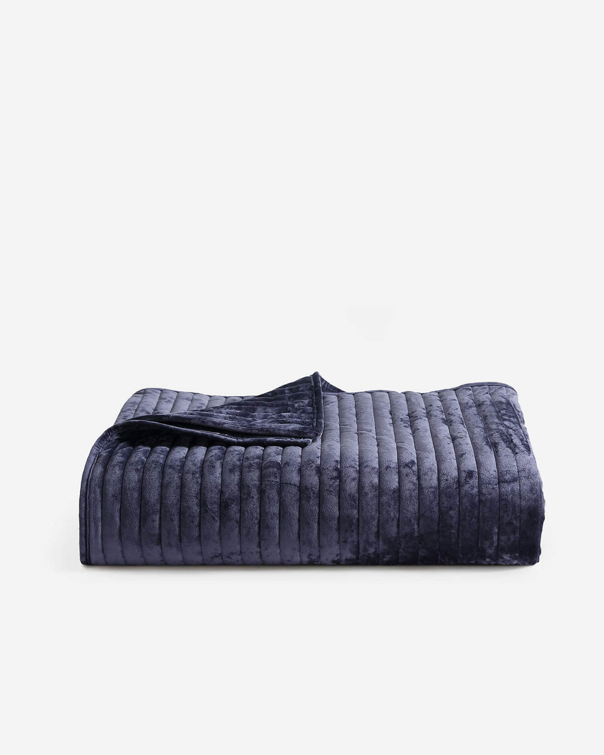 Dark blue velvet quilt with quilted channel stripes and a folded edge.