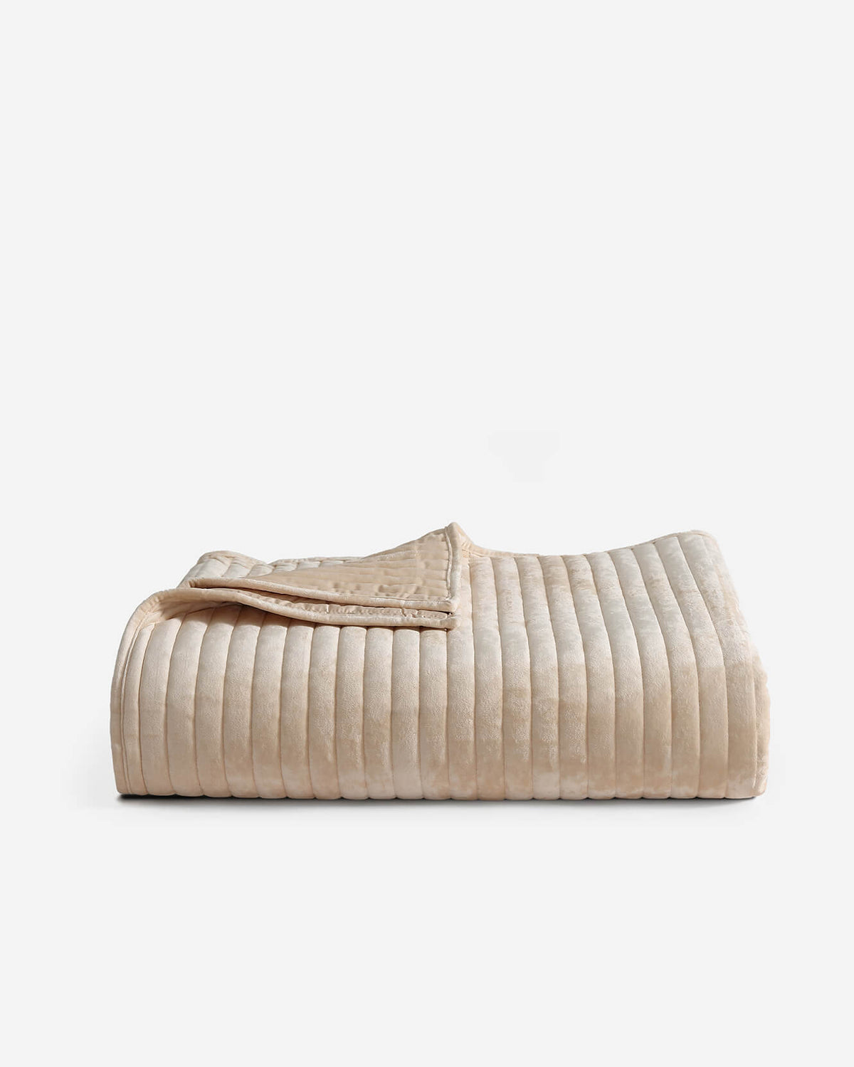 Cream velvet quilt with channel stripes and a neatly stitched folded edge.