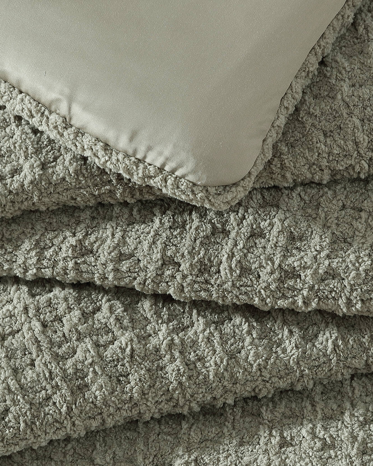 Waffle comforter with stitched edge and smooth backing, sage-green close-up