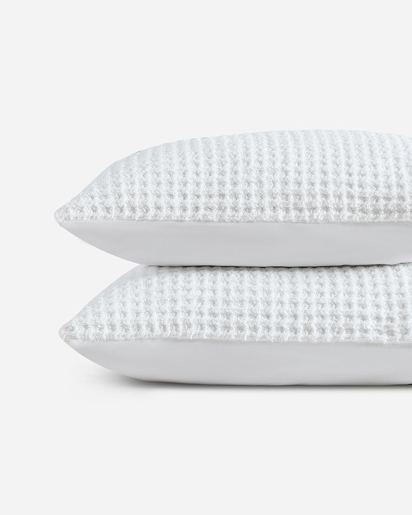 White waffle comforter bundle shams, two stacked textured pillows in light gray-white