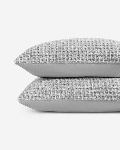 Waffle comforter bundle shams, two stacked textured square pillows in gray