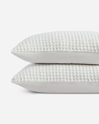 Off-white waffle shams with light gray backing, stacked side by side