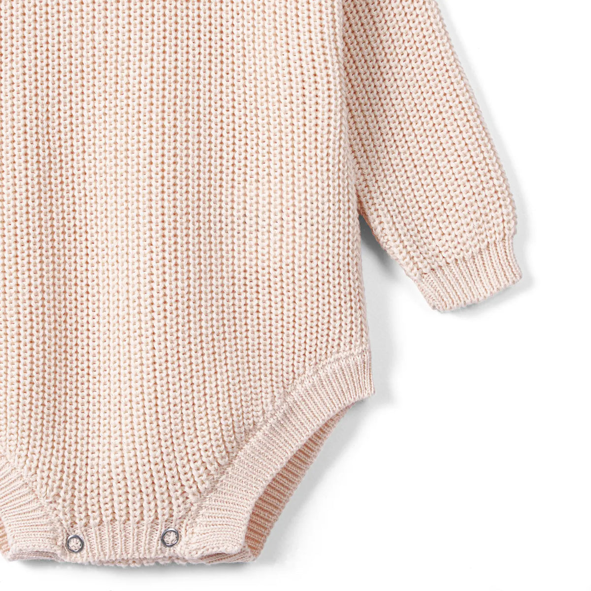 Beige chunky knit baby romper with ribbed cuffs and snap-button leg opening