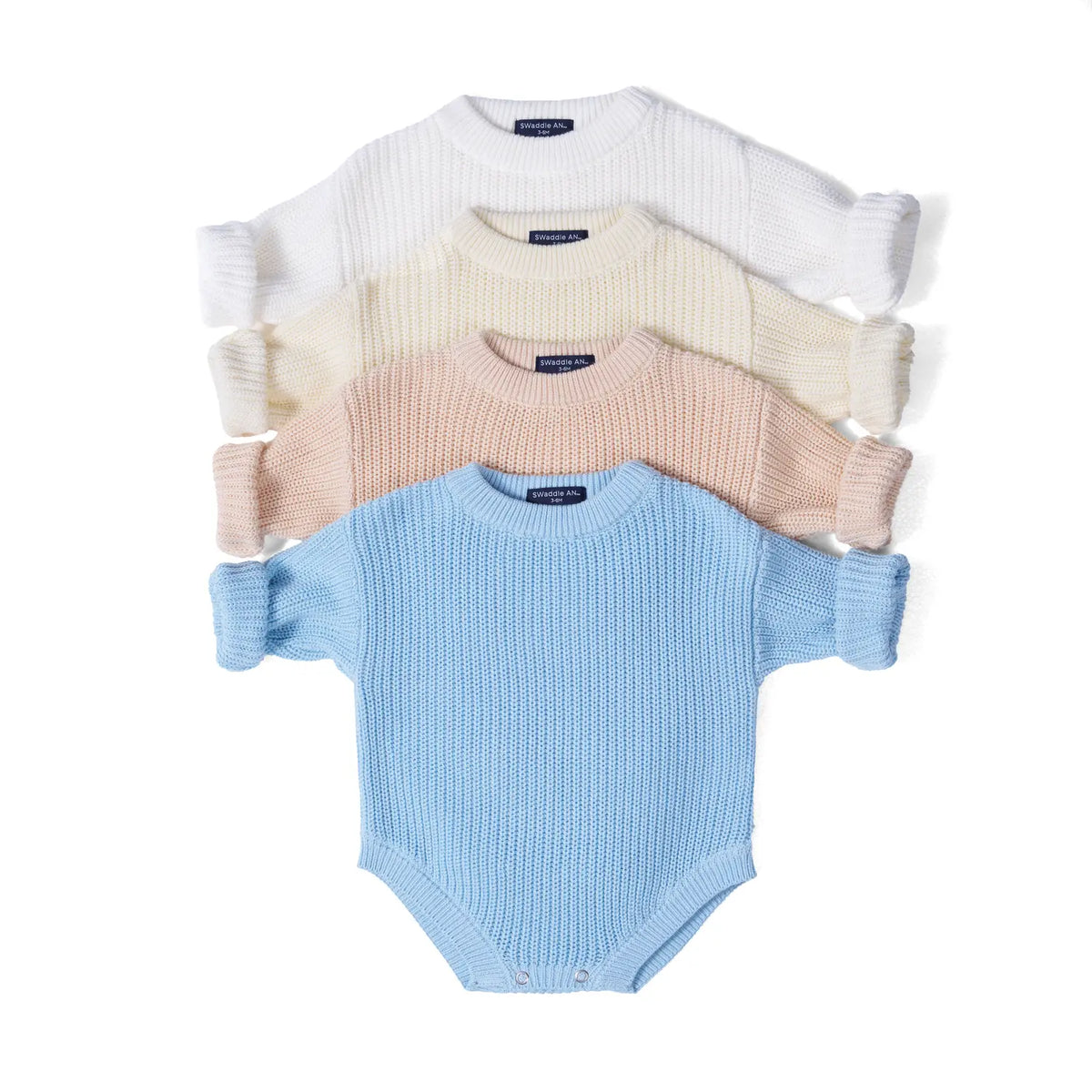 Baby knit romper set with cream, pink, and blue long sleeves and snap closures.