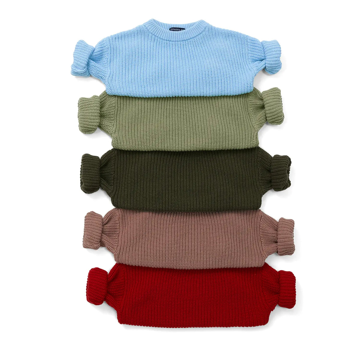 Stack of knit baby sweaters in blue, green, mocha, and red