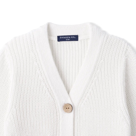 White knit cardigan with V-neck and button front; Swaddle AN label visible.