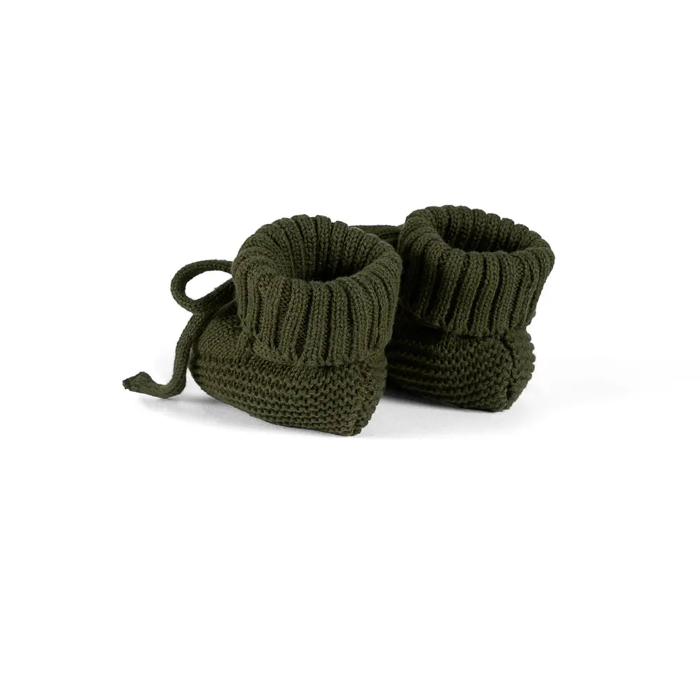 Forest green knitted baby booties with ribbed cuffs and lace ties, side-by-side pair