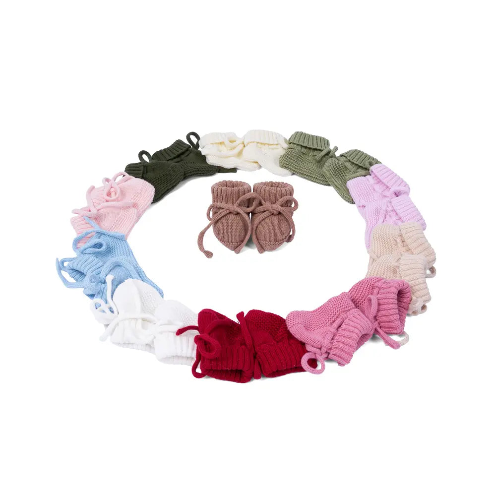 Circular display of knitted baby booties in mixed colors with small center
