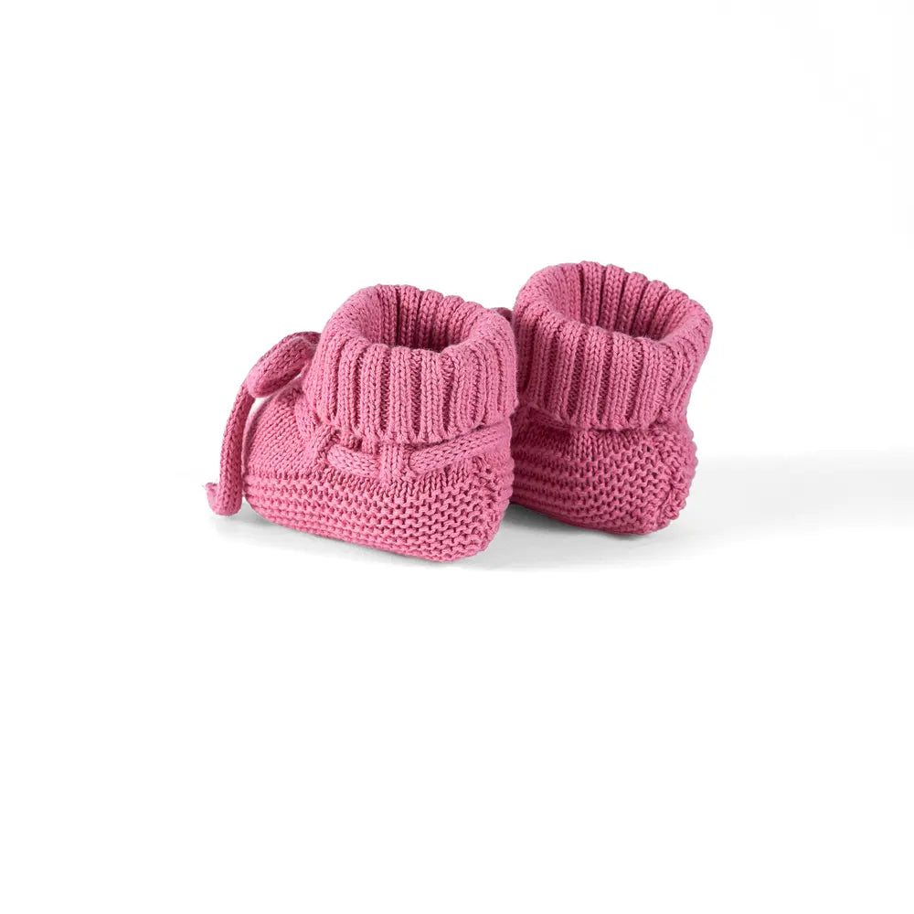 Rose pink knitted booties viewed from side with lace bow ties