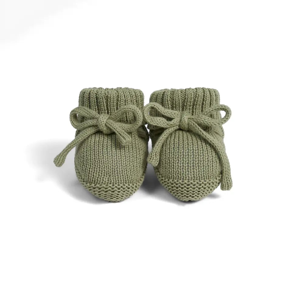Sage green knitted baby booties with bow ties and ribbed cuffs, pair