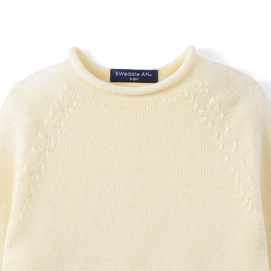 Cream knit baby rollneck sweater close-up of ribbed collar and neckline