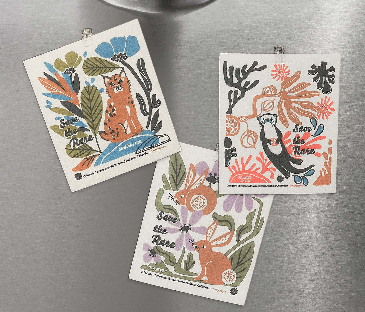 Set of three Swedish dishcloths with different wildlife illustrations in blue and orange