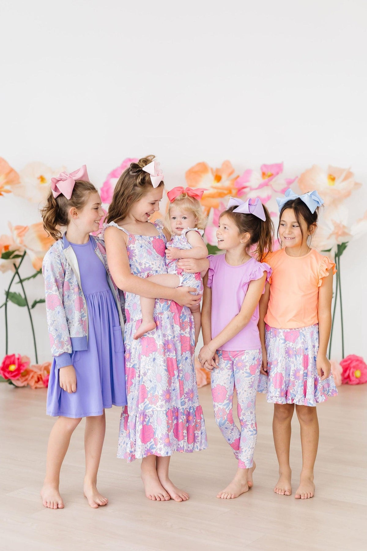 Pastel floral ruffle romper with cross-back straps and gathered waist on toddler