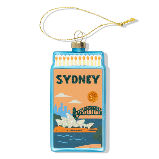 Sydney-themed matchbook ornament with hanging gold cord, blue frame and city skyline art