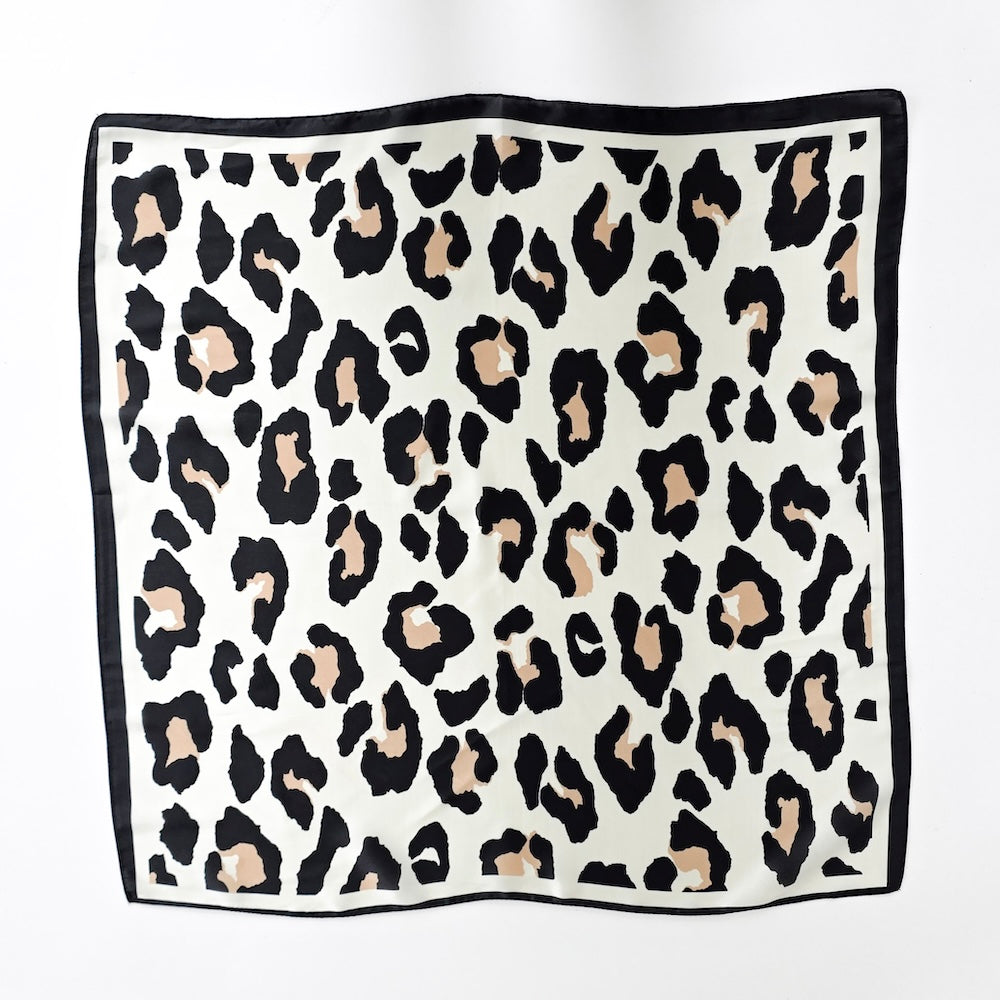 Cream leopard square scarf with black spots and dark border, folded flat