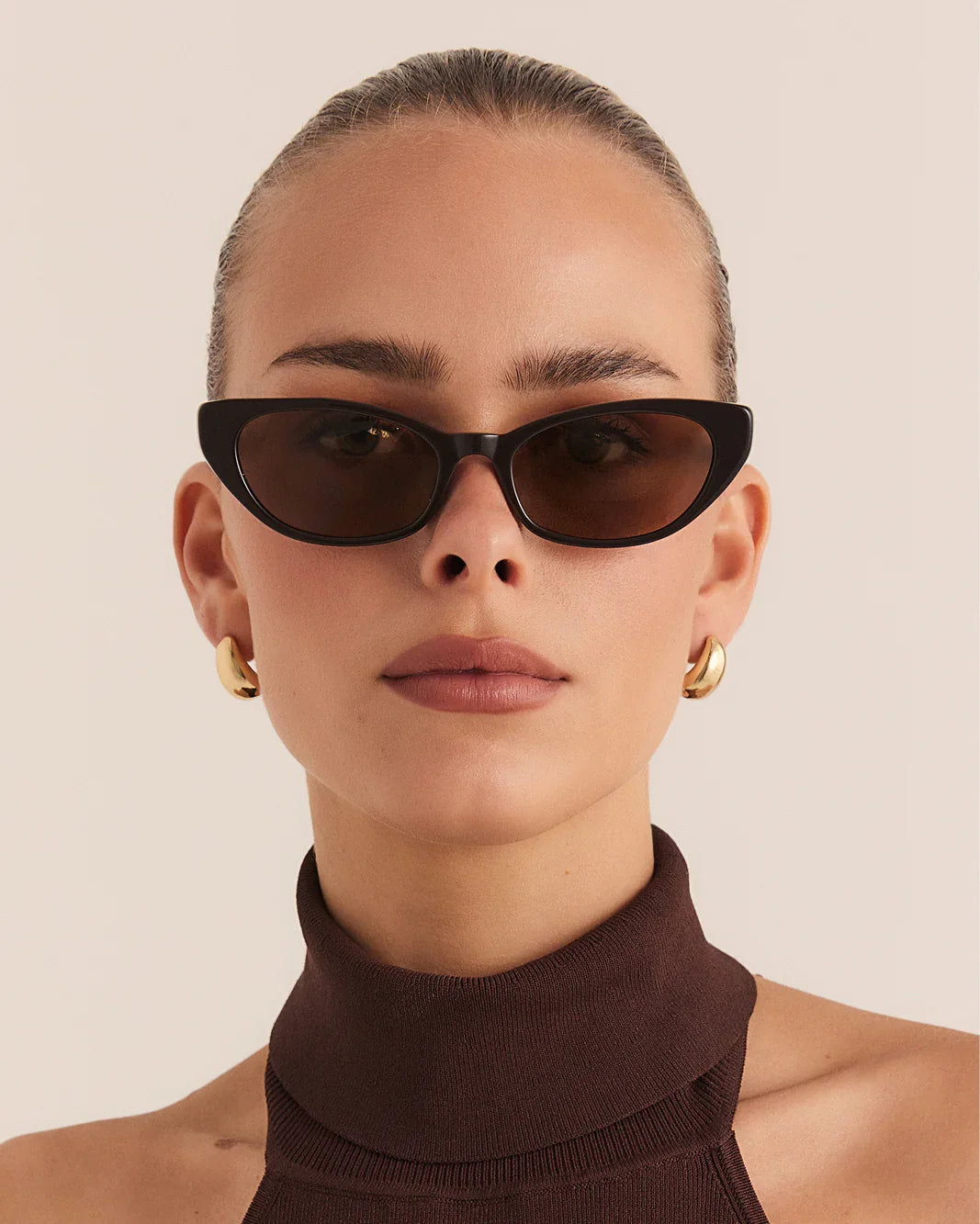 Dark espresso cat-eye sunglasses with dark lenses and slim arms