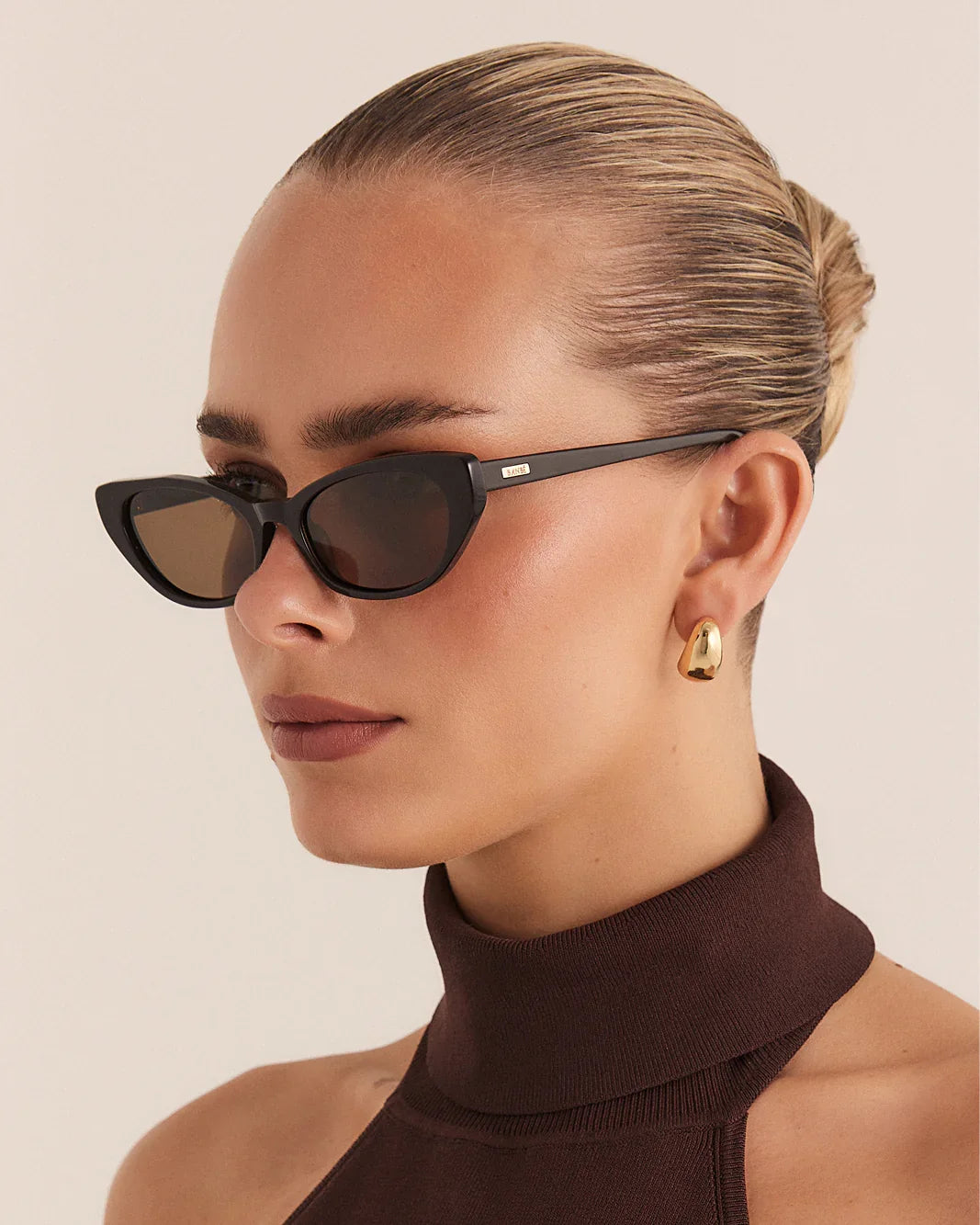 Dark espresso cat-eye sunglasses on model with dark tinted lenses