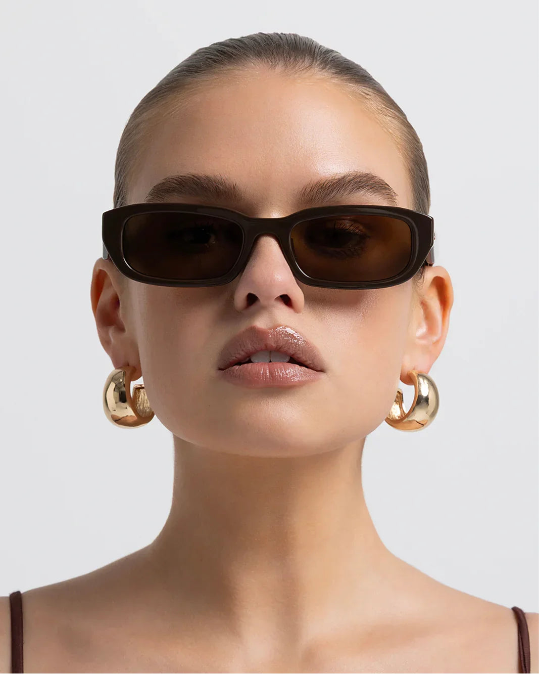 Polarized sunglasses with dark frame and brown lenses, front view