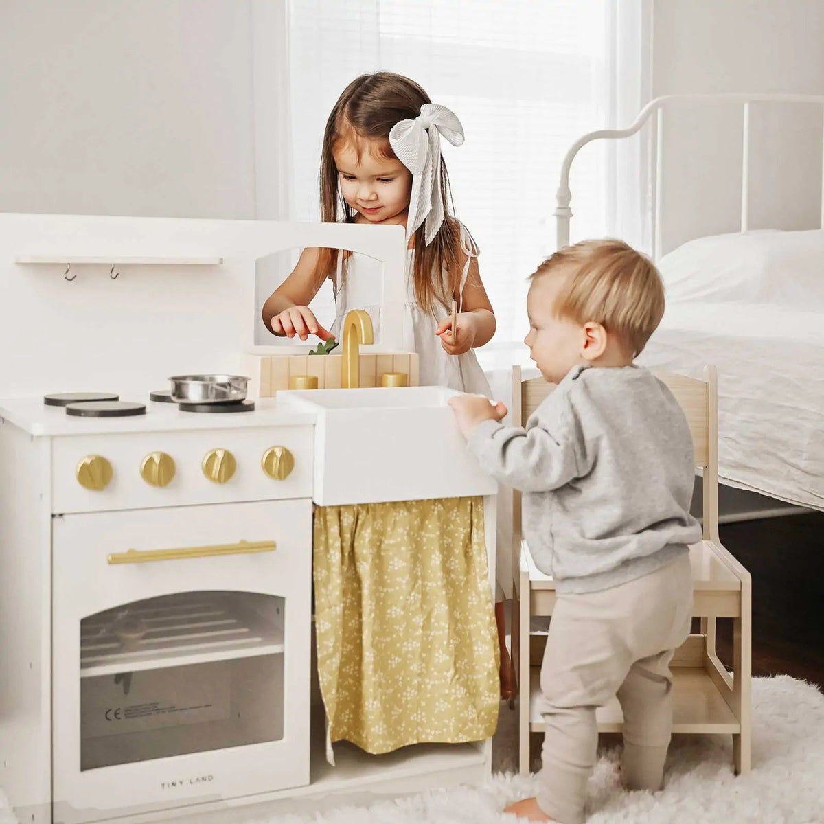 Wooden play kitchen with oven, sink, stovetop and gold knobs