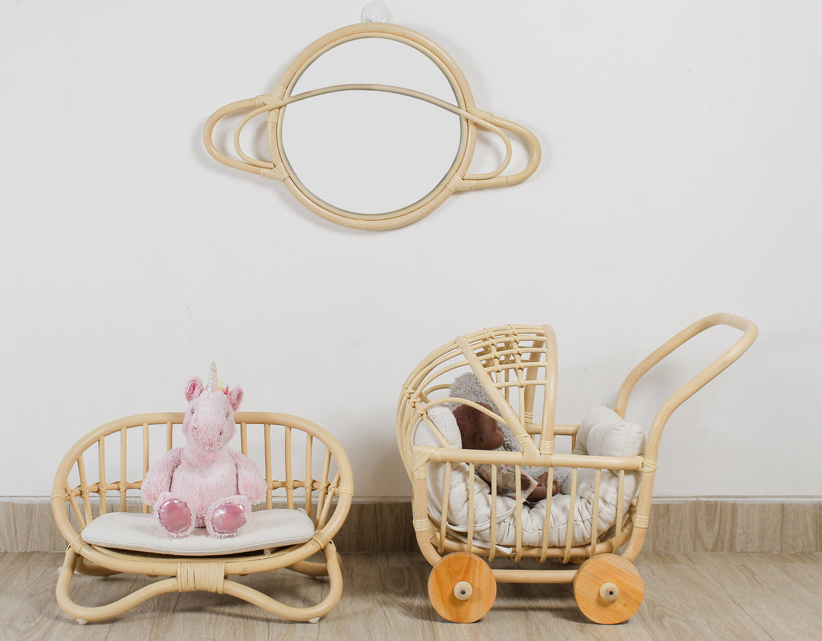 Natural rattan miniature doll couch with white cushion, shown beside a matching toy pram