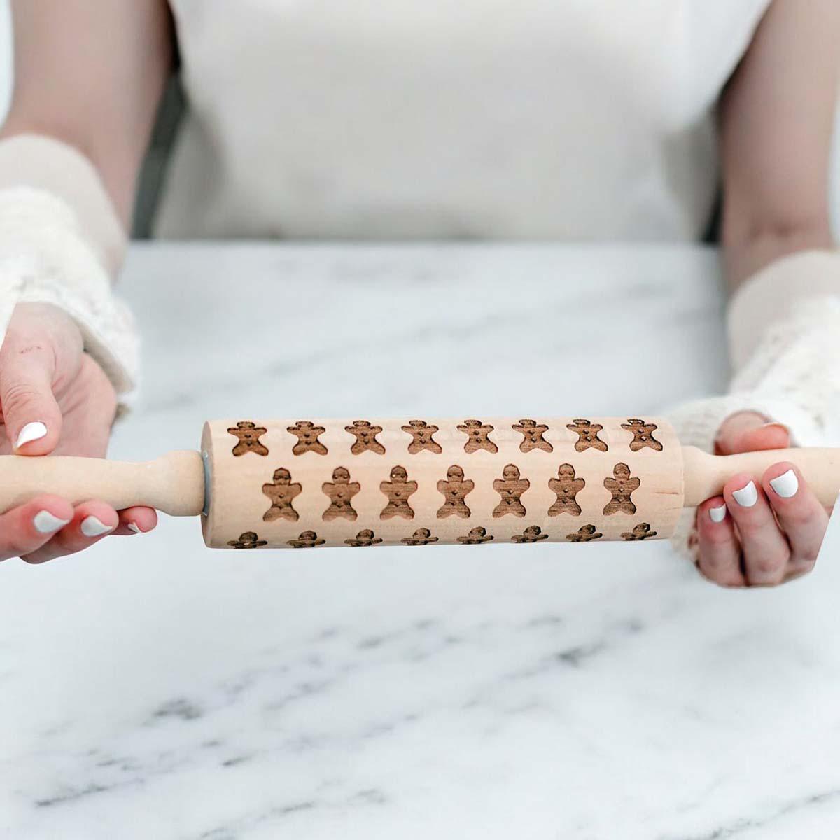Wooden Christmas rolling pin with gingerbread man cookie pattern and light handle