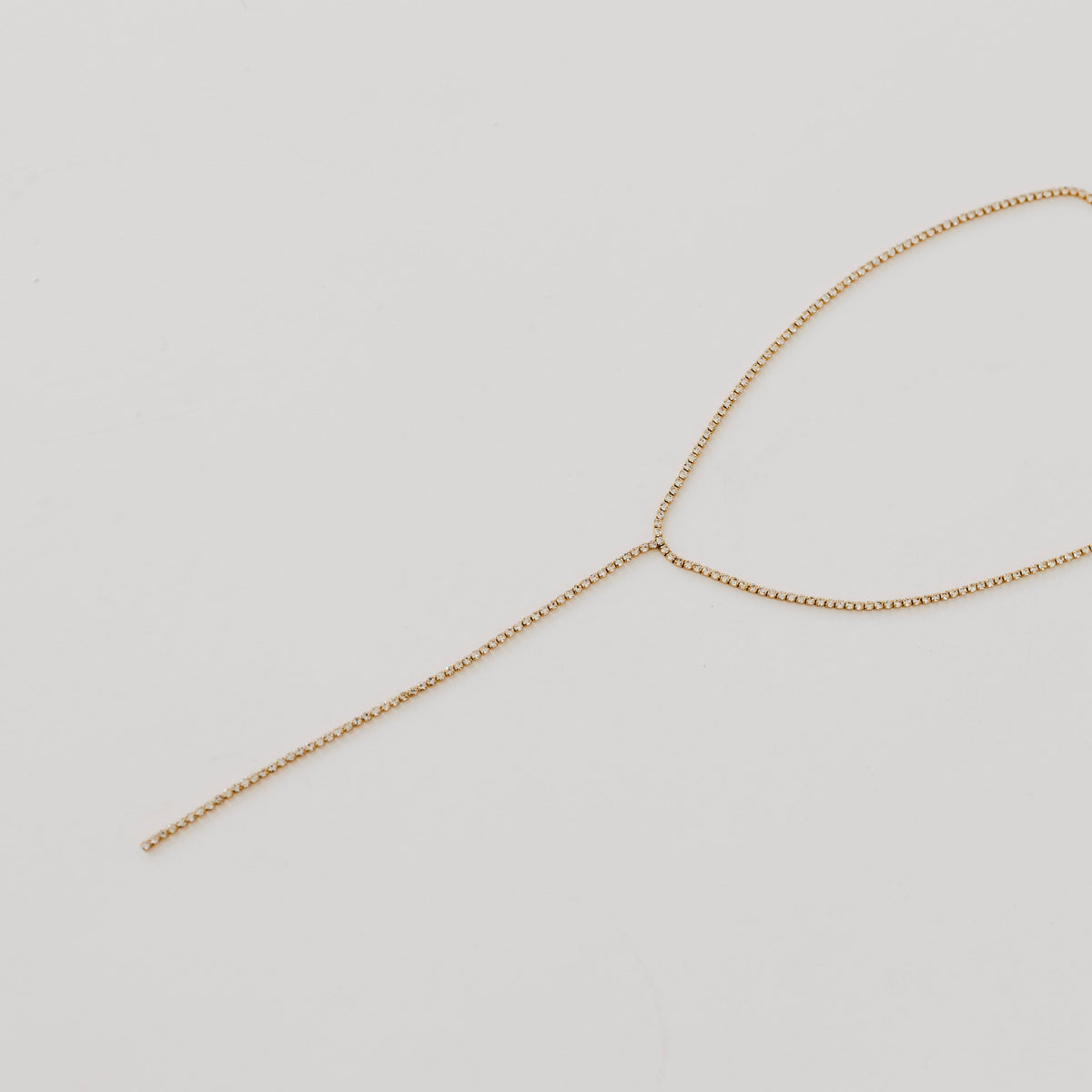 Gold tennis lariat necklace with adjustable drop chain