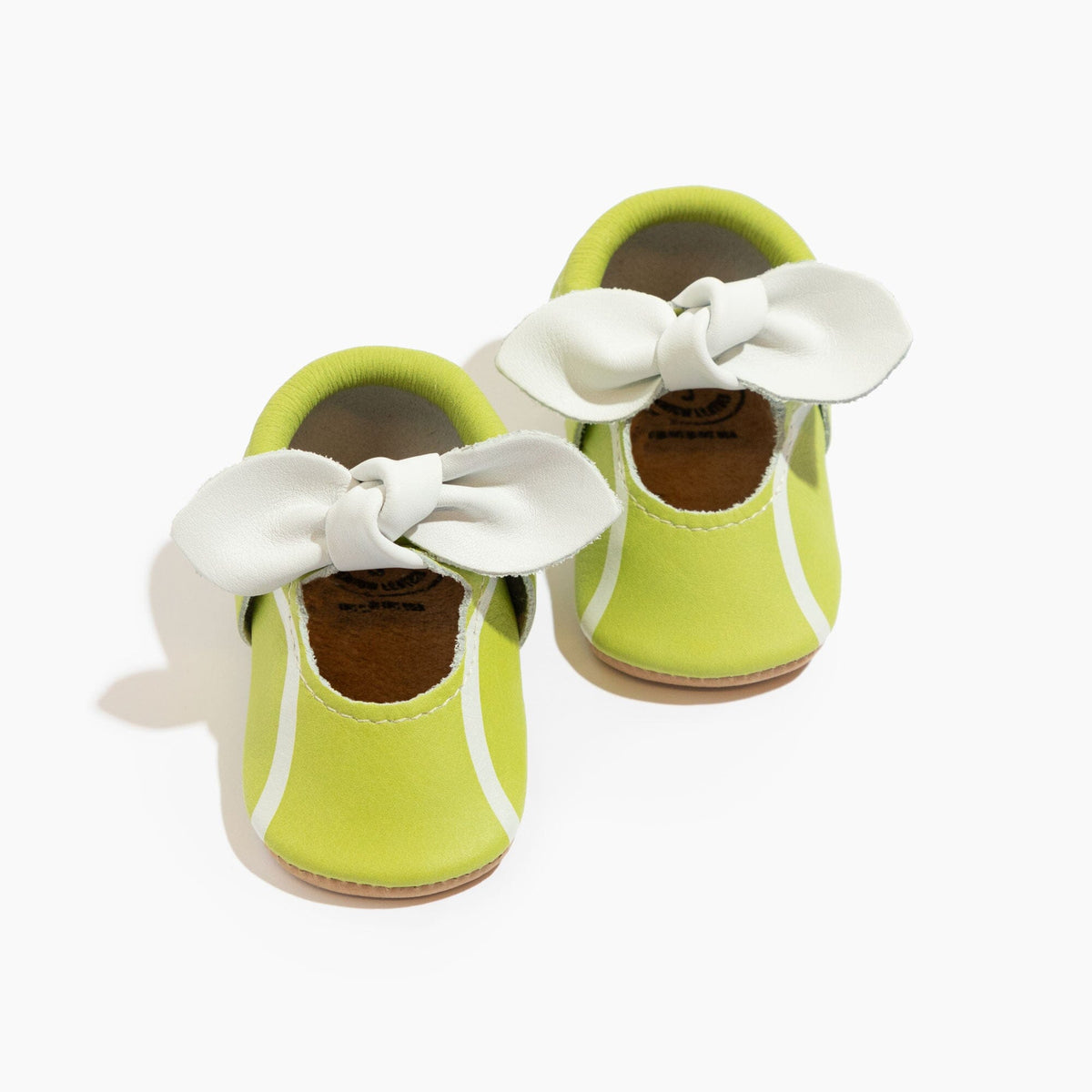 Lime green baby shoe with white knotted bow and soft sole