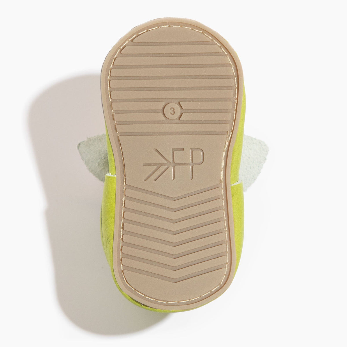 Baby shoe outsole bottom with tread lines and FP logo, lime green