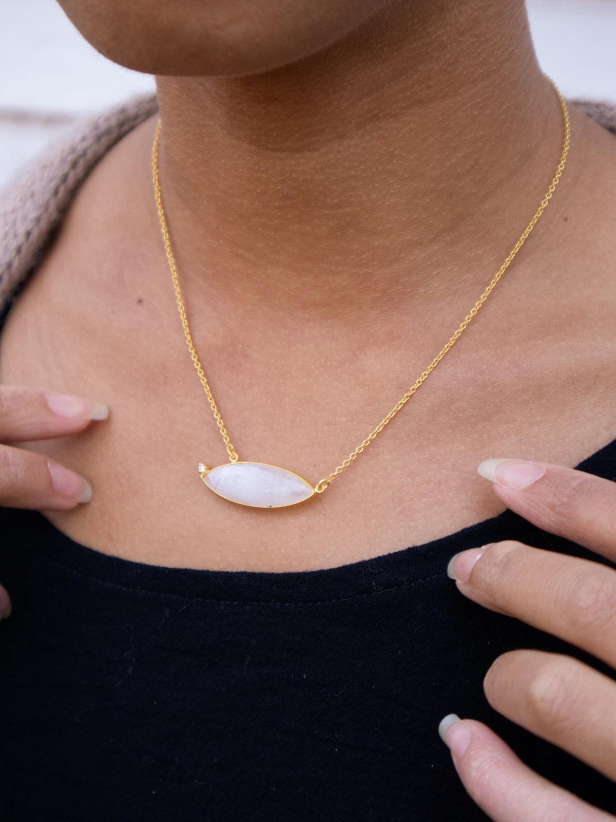 Gold chain necklace with oval milky white stone pendant