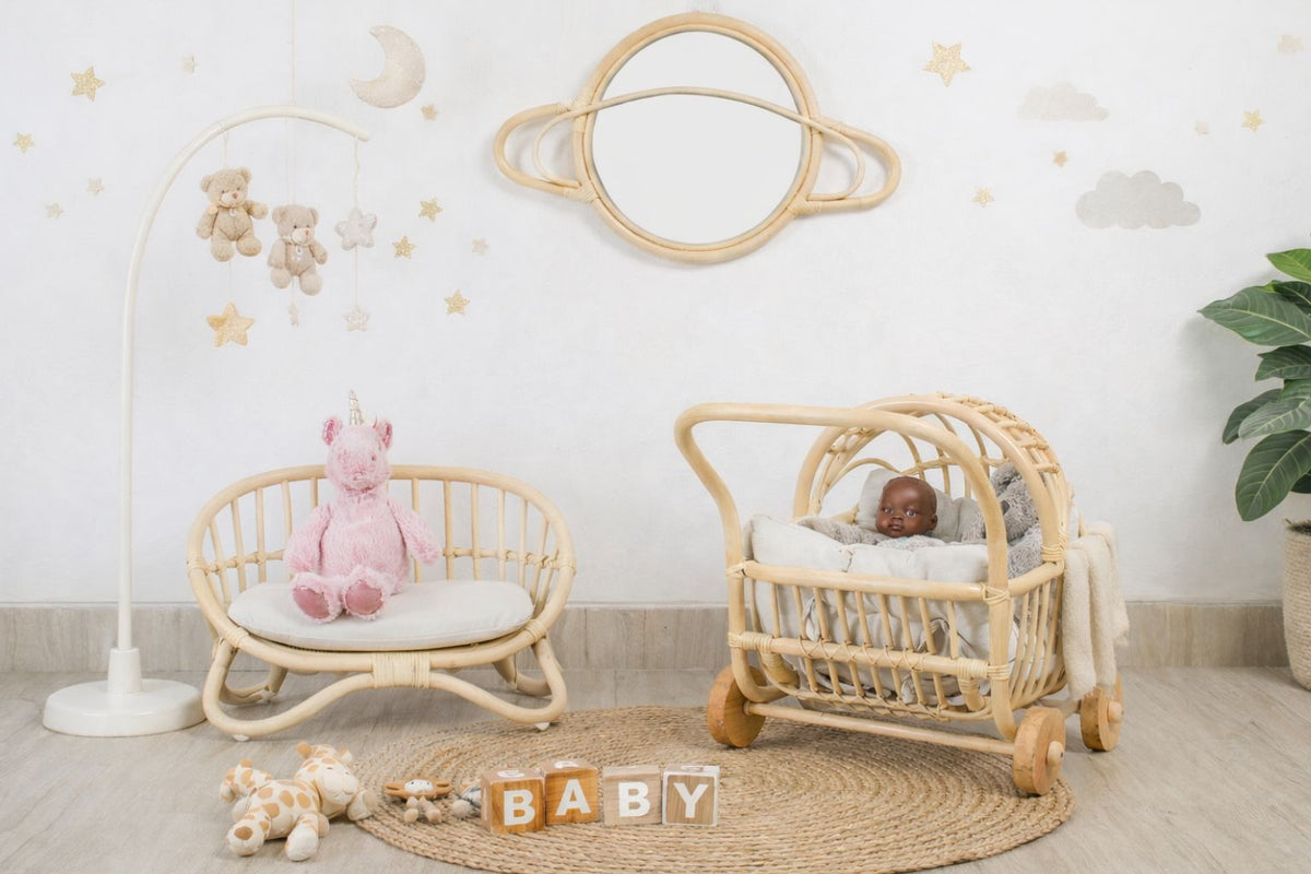 Natural rattan miniature doll couch with white cushion, shown beside a matching toy pram