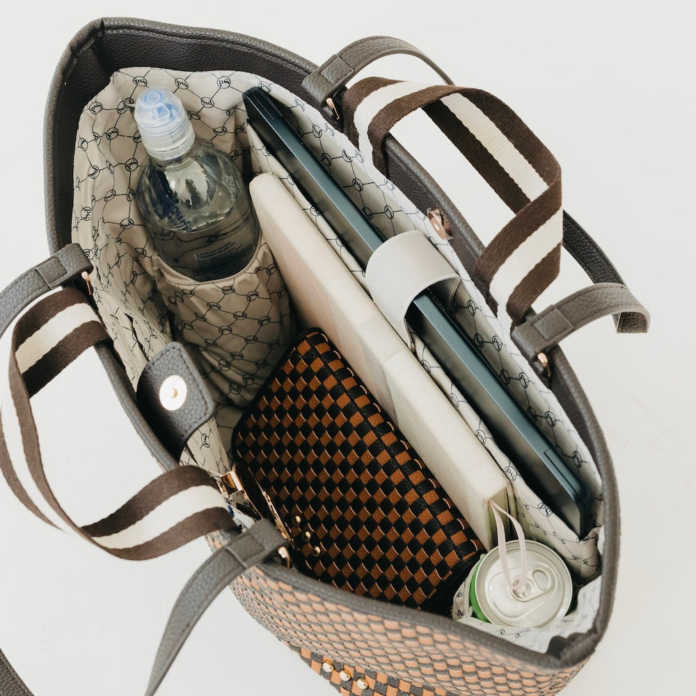 Woven organizer tote bag interior with bottle pocket and striped handle straps