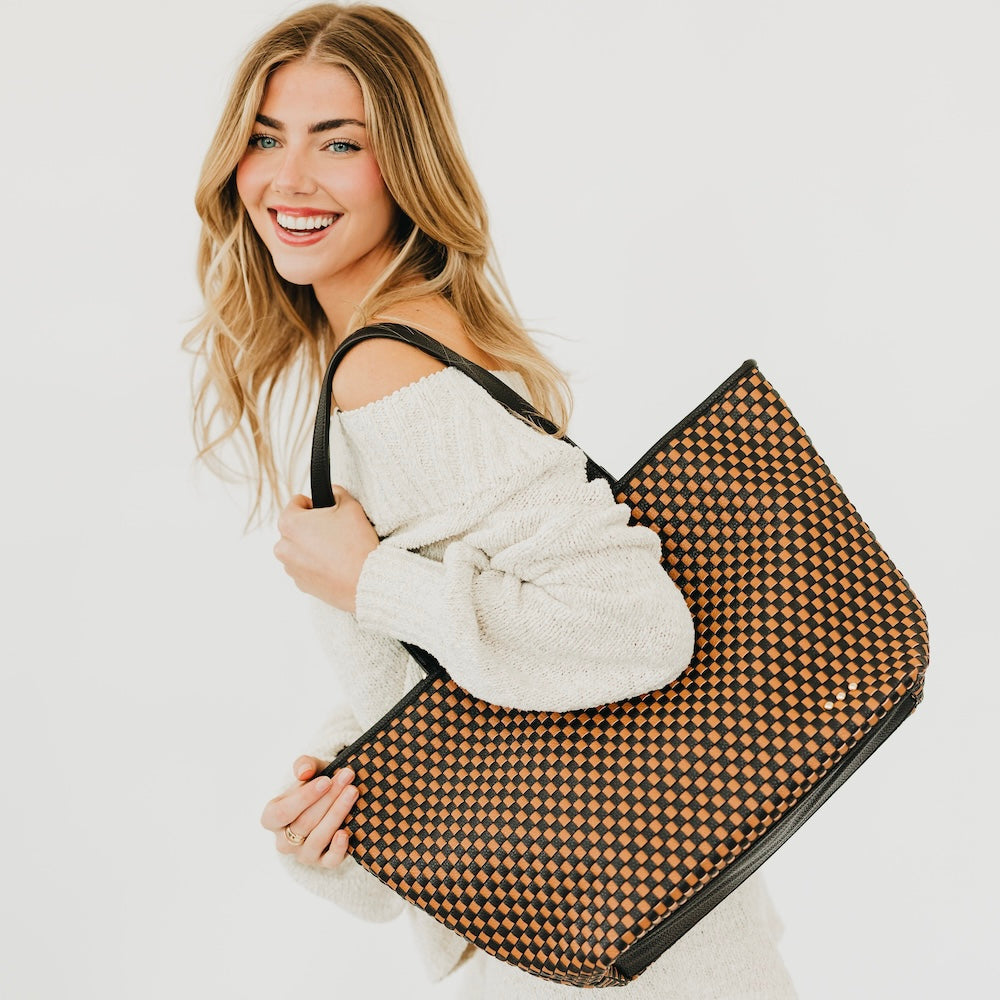 Woven checkered tote bag in black and burnt orange with black straps