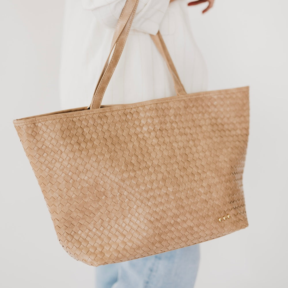 Woven tan organizer tote bag with tan handles and small gold snap detail