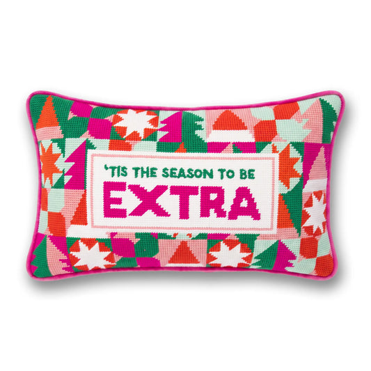 Geometric needlepoint Christmas pillow with 'TIS THE SEASON TO BE EXTRA' text.