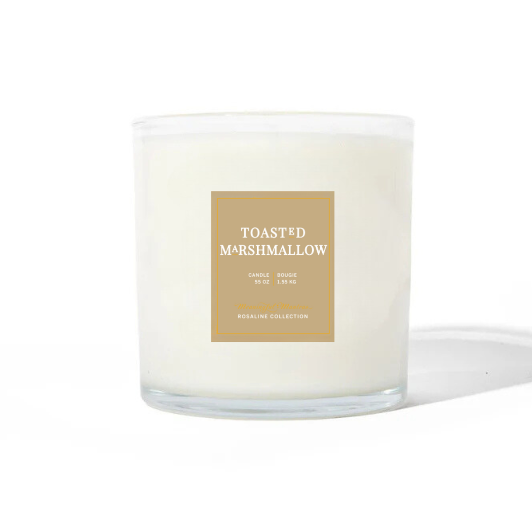 Toasted Marshmallow candle in a clear glass jar with a tan label