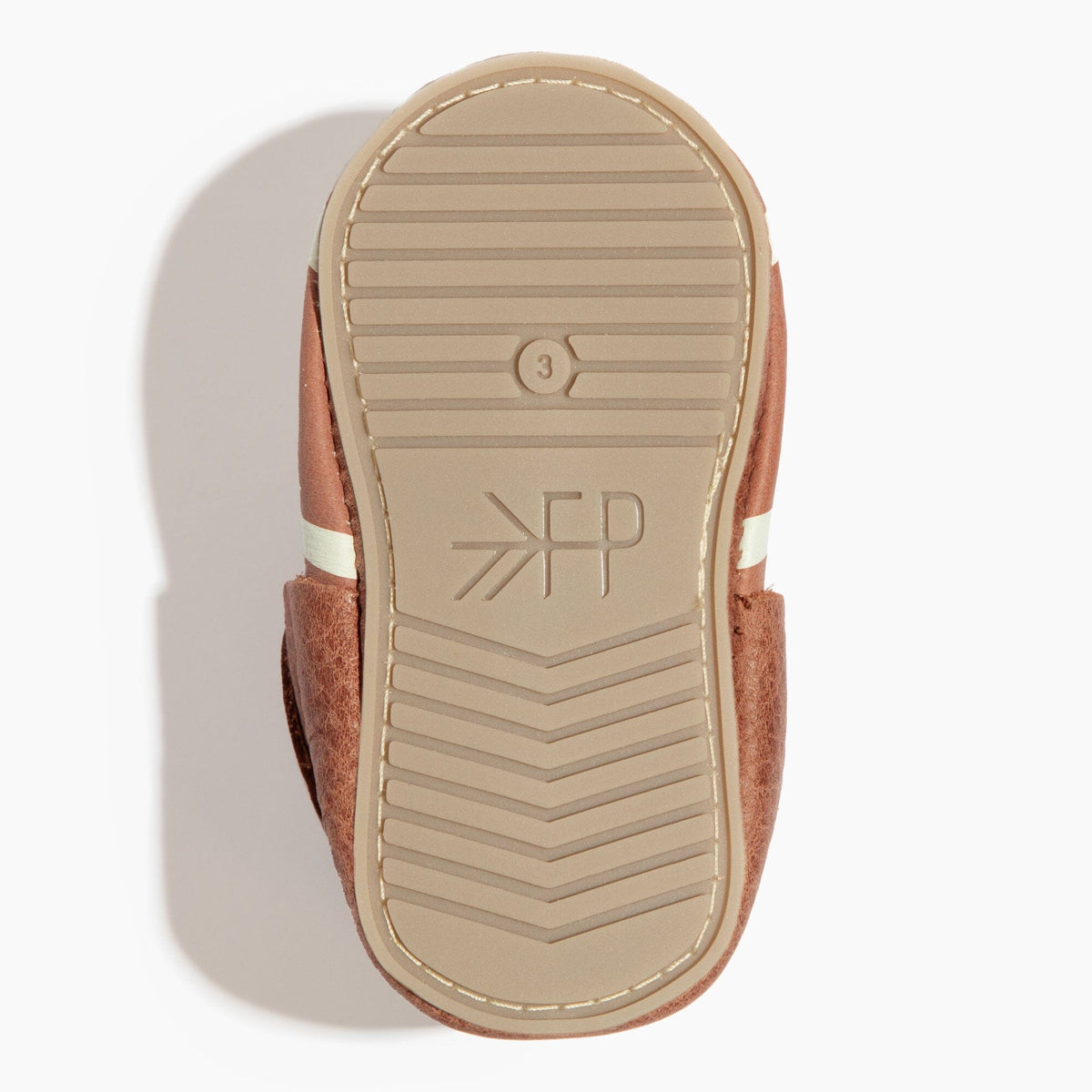 Brown baby shoe outsole with ridged traction lines and YR branding mark