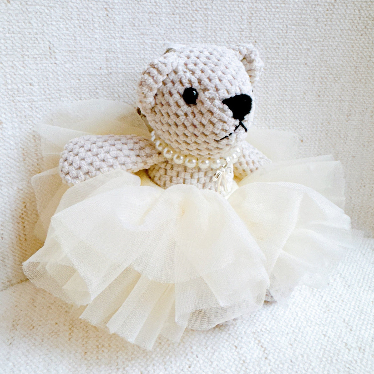 Bear bag charm with white tulle scrunch tutu and pearl necklace