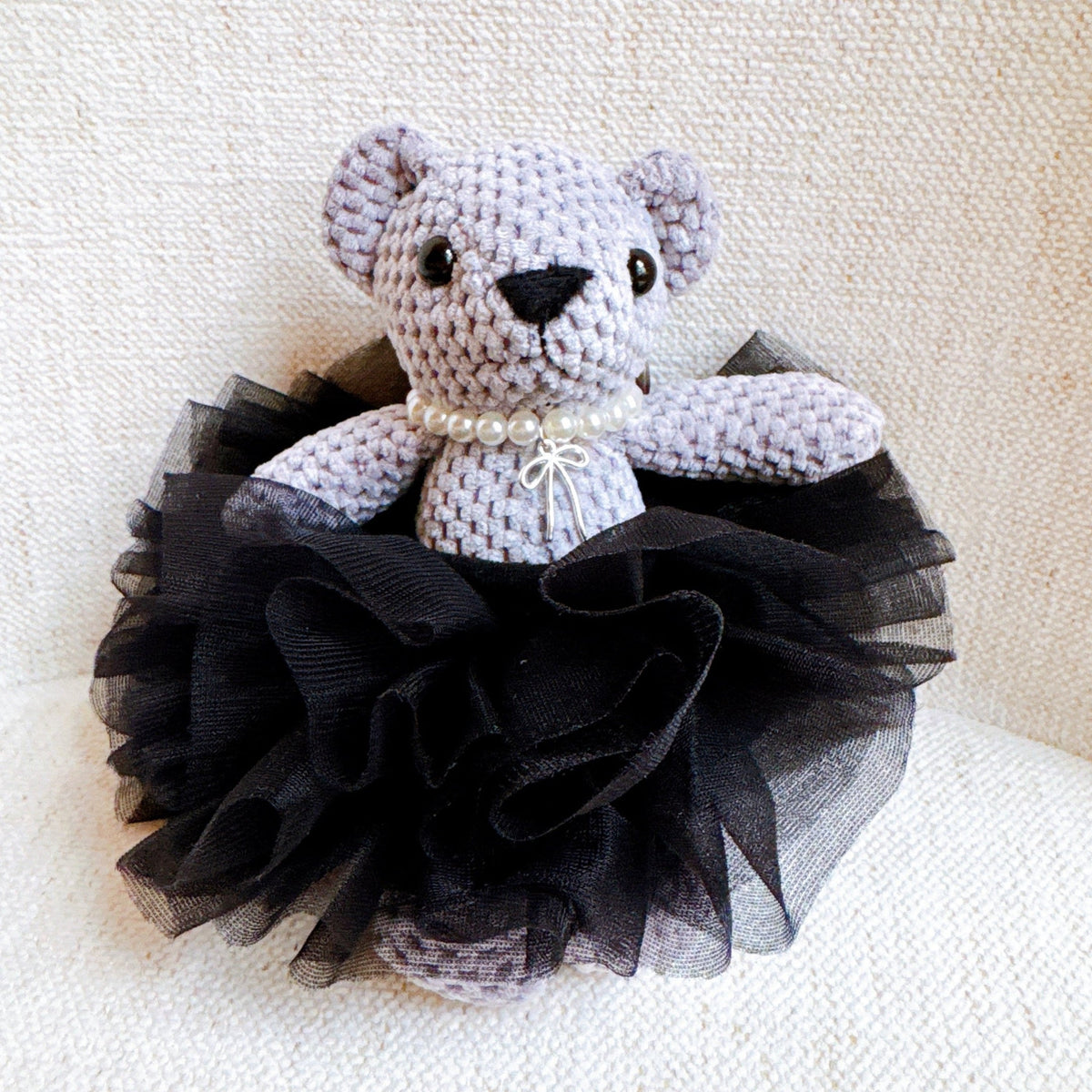 Bear bag charm with black lace tutu and pearl collar, crocheted bear