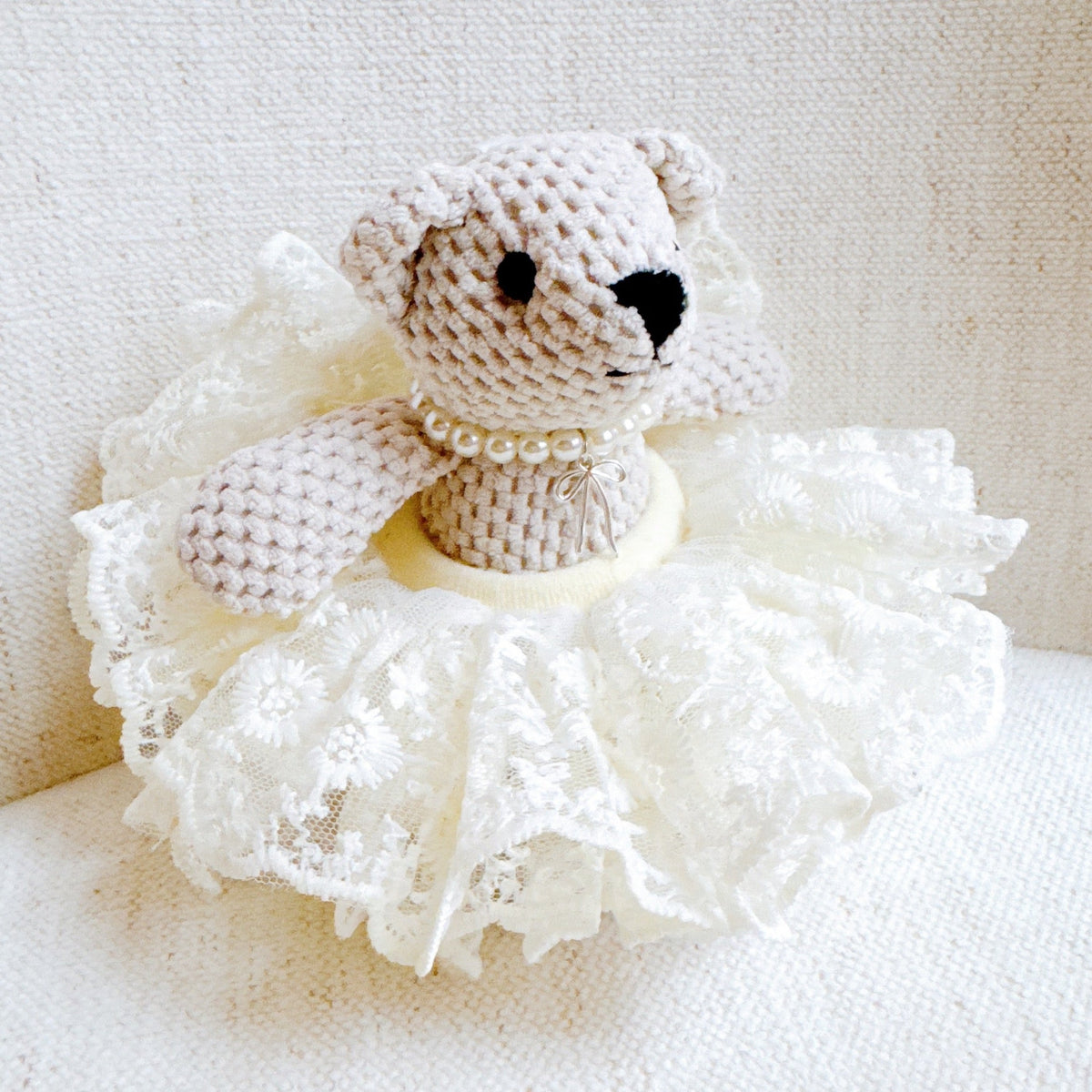 Crocheted cream bear bag charm with white tutu skirt and pearl collar