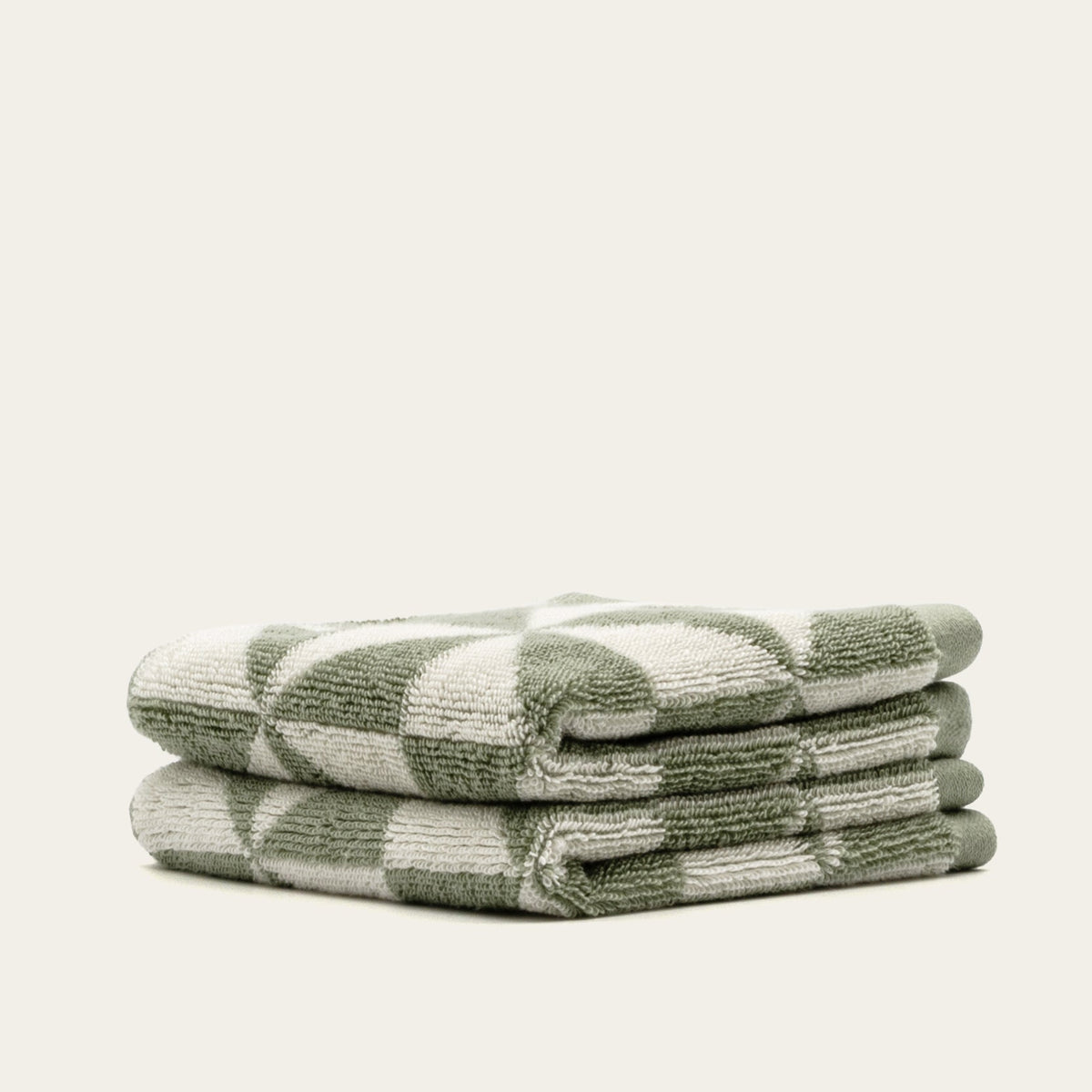 Sage green and ecru geometric check cotton towels, side view folded stack