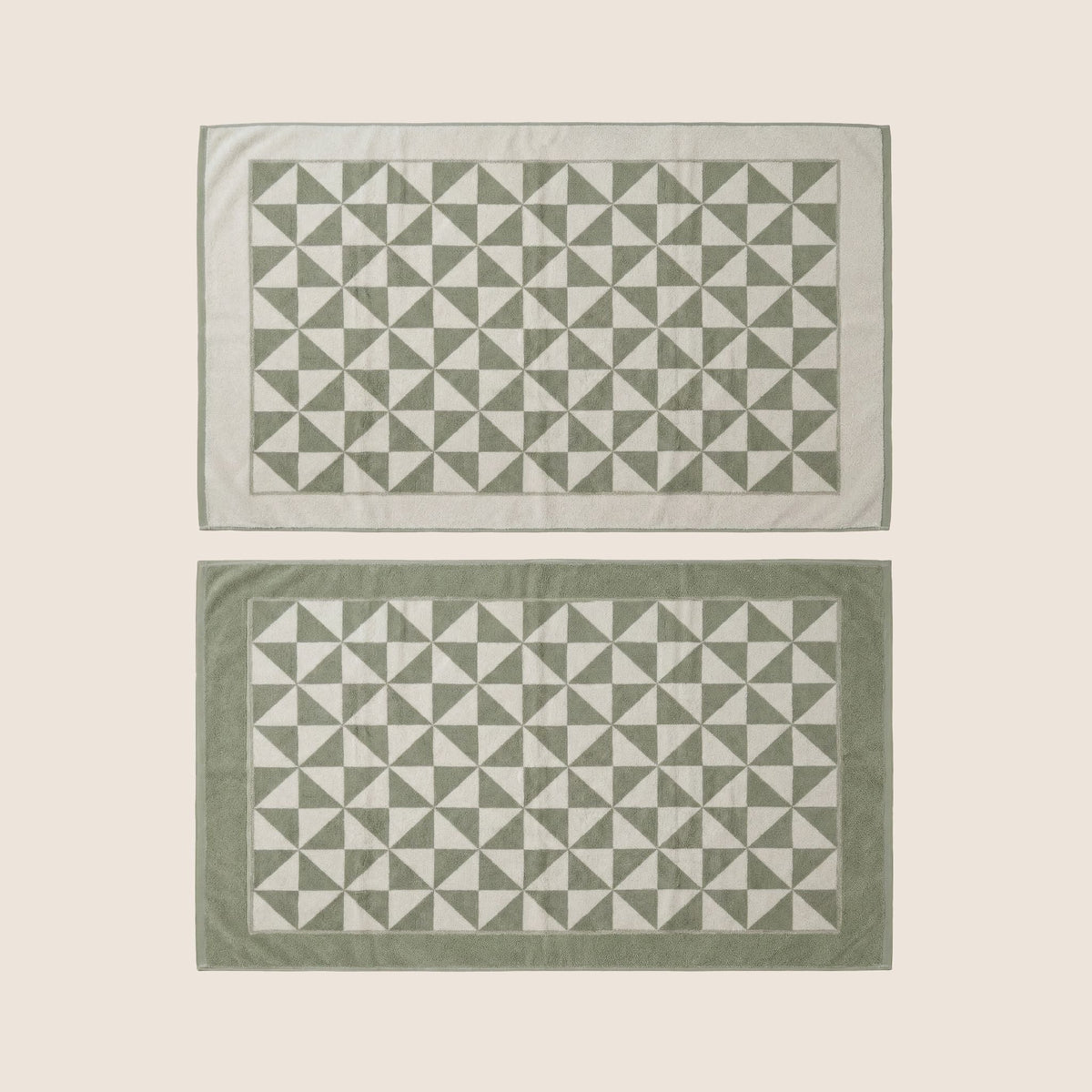 Set of geometric cotton towel pieces in sage green and ecru, rectangular layout.