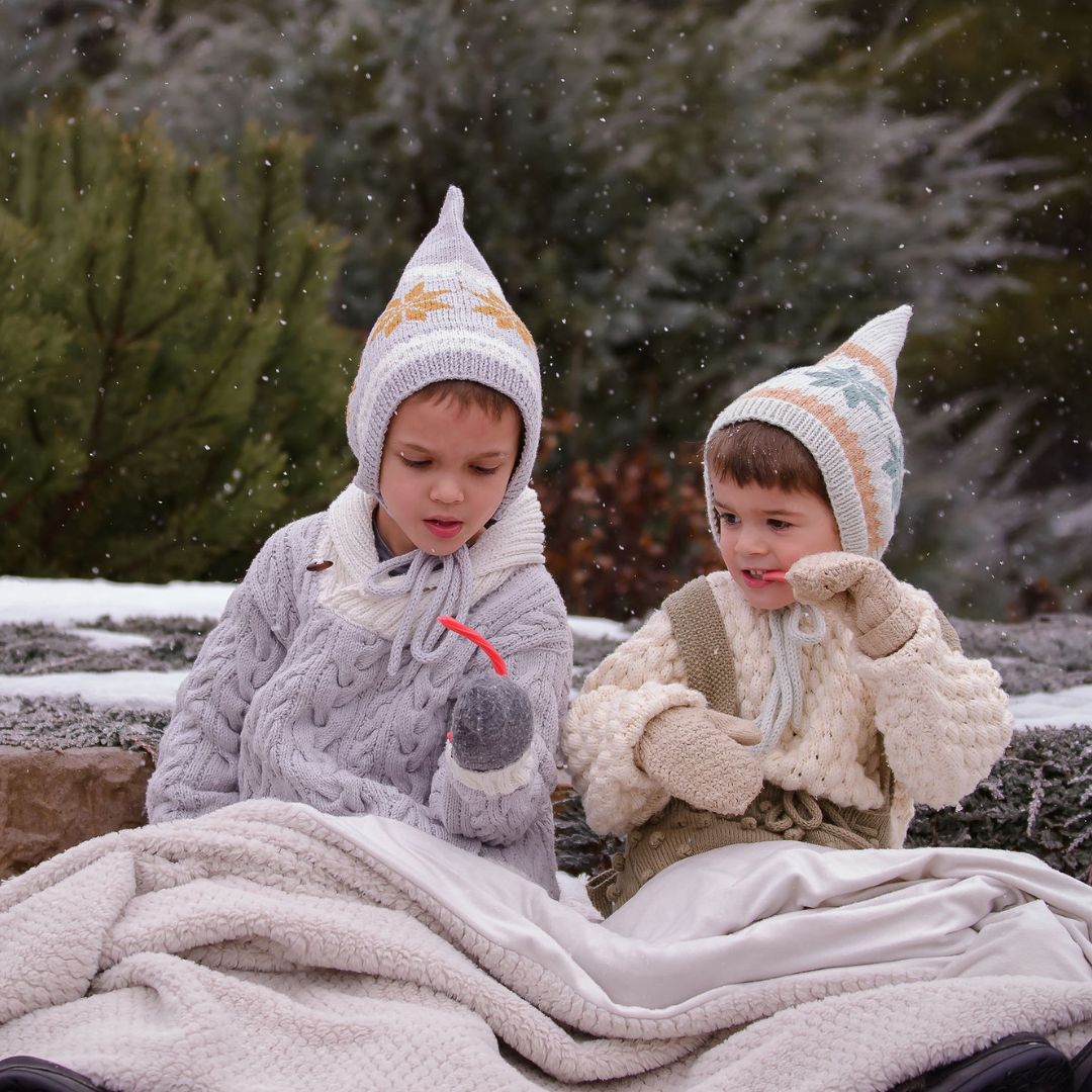Knit pixie hats on kids: gray with Nordic motifs and cream knit cap