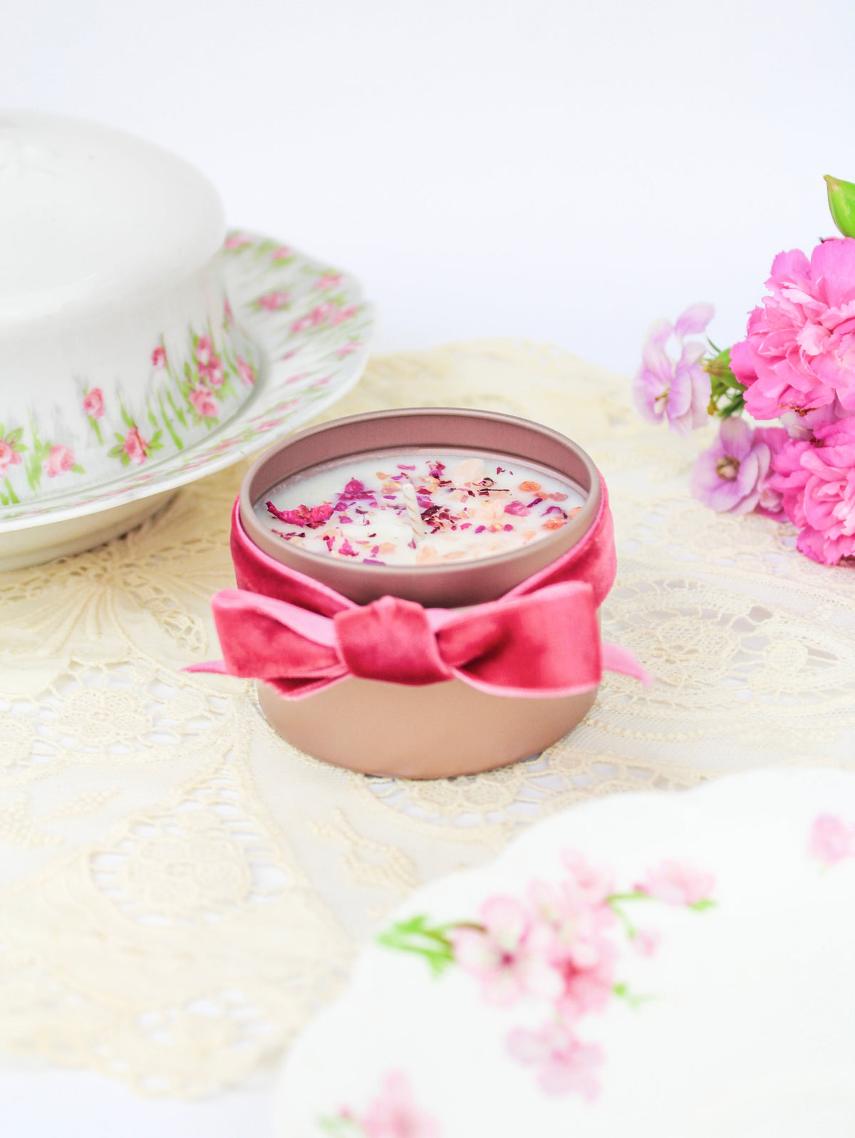 Botanical soy wax candle in rose-gold tin with pink ribbon and dried flower wax