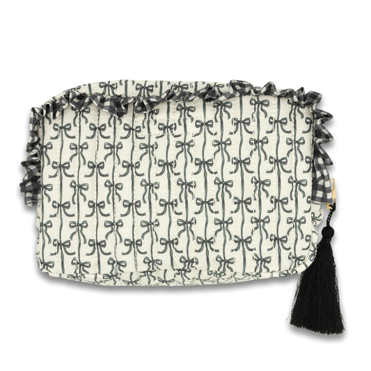 Quilted cosmo bag with black bow, tassel pull, and grid-patterned fabric